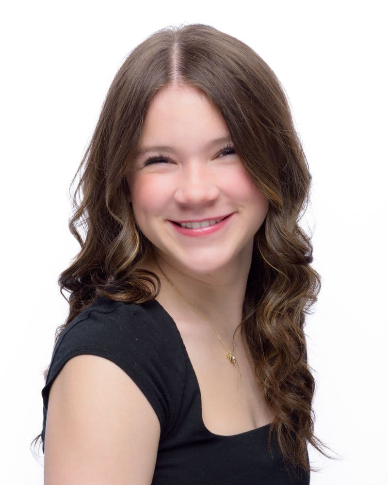 Portrait of a smiling woman with curly brown hair