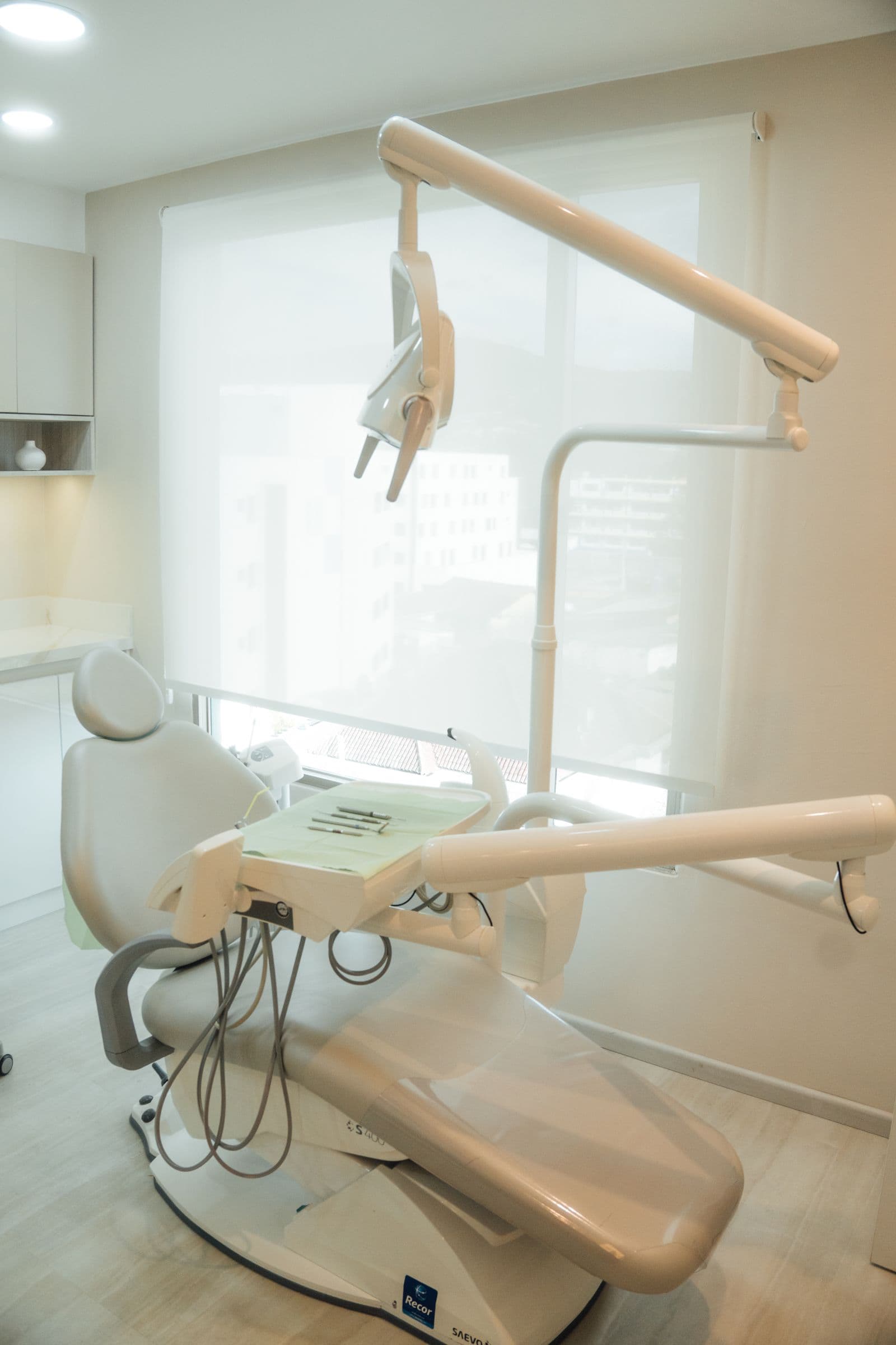 A bright, modern treatment room with large windows and natural light