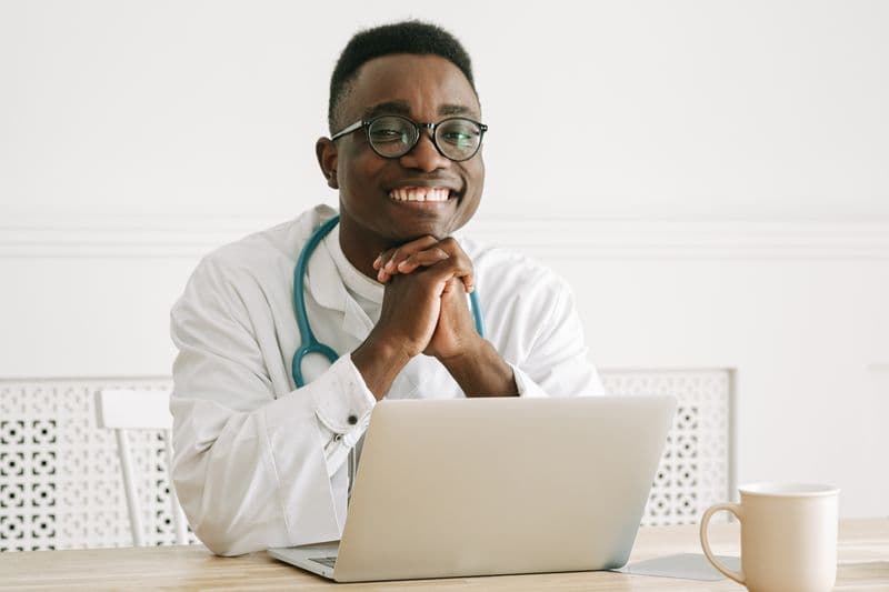 Portrait of Dr. Nathan Park, DMD, MS, smiling in a white coat
