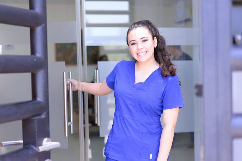 Portrait of Jordan Ellis, RDA, smiling in blue scrubs