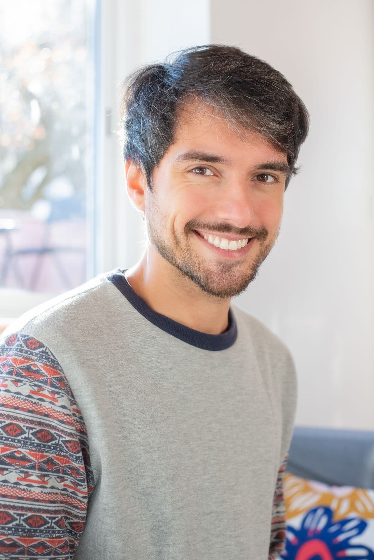 An adult man smiling confidently with a healthy smile
