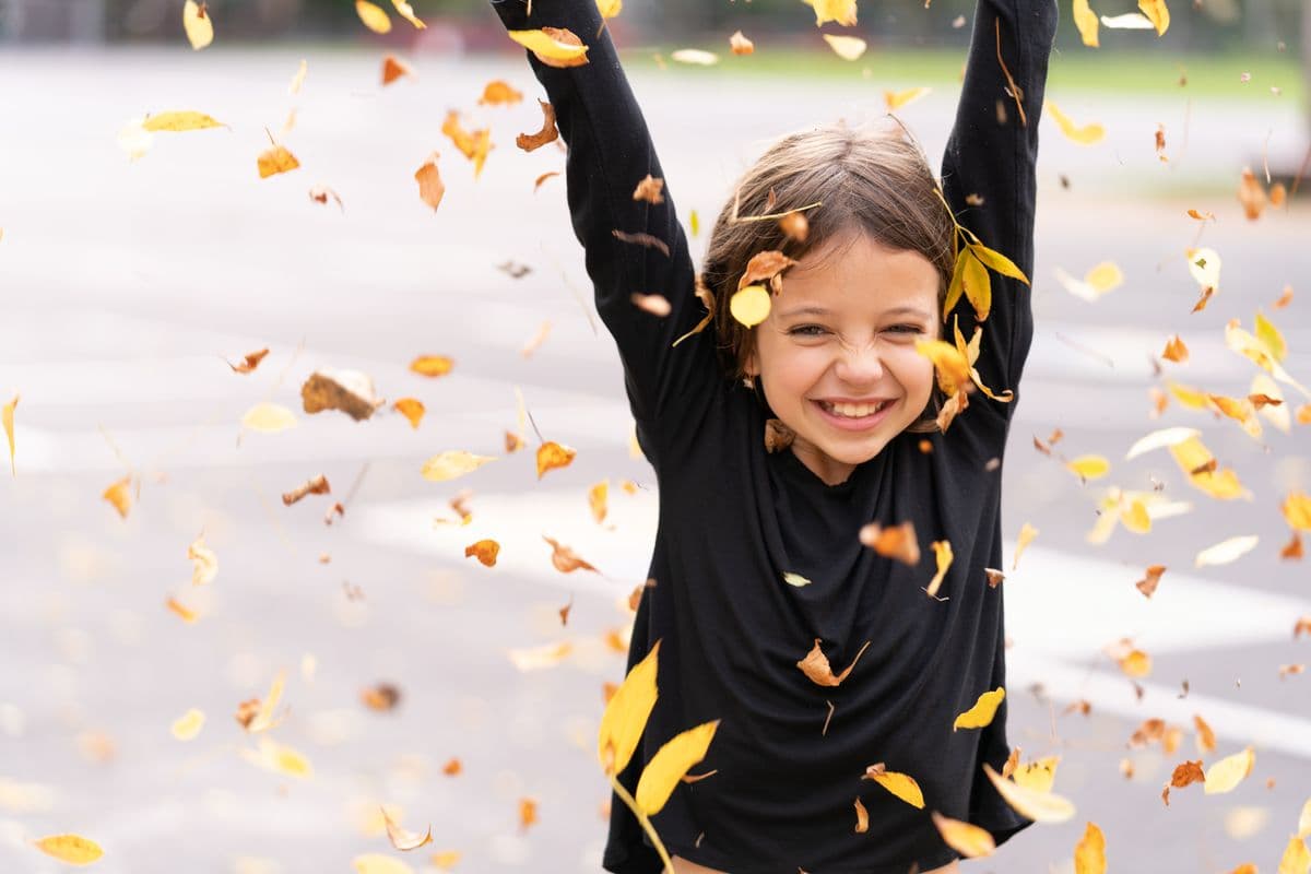 A joyful young girl smiling and playing outdoors